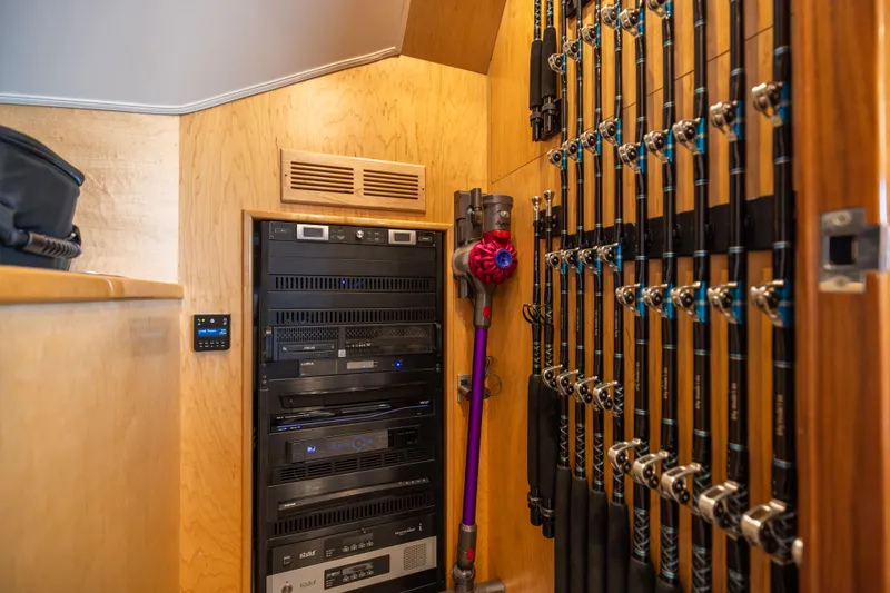 Slide: The Image of Storage area in a 2020 Viking 80 Convertible yacht with fishing rods and electronic equipment. - 17