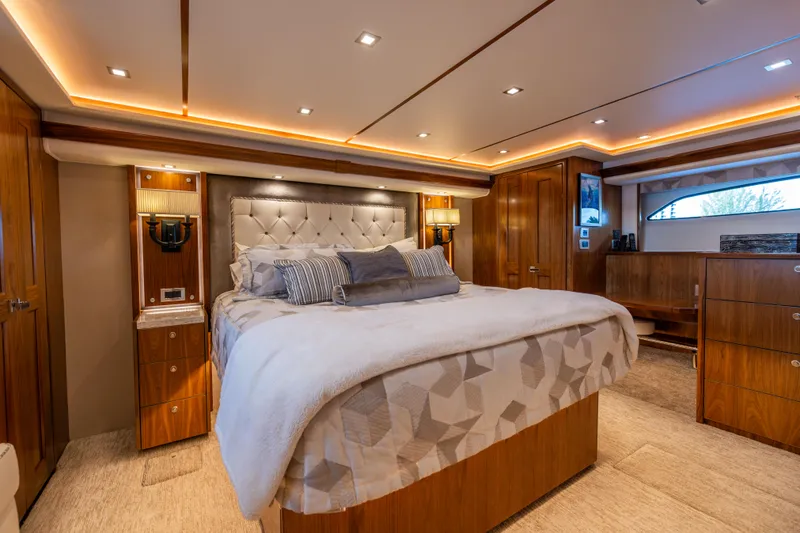 Slide: The Image of Luxurious bedroom interior of 2020 Viking 80 Convertible yacht with elegant wood finishes. - 21
