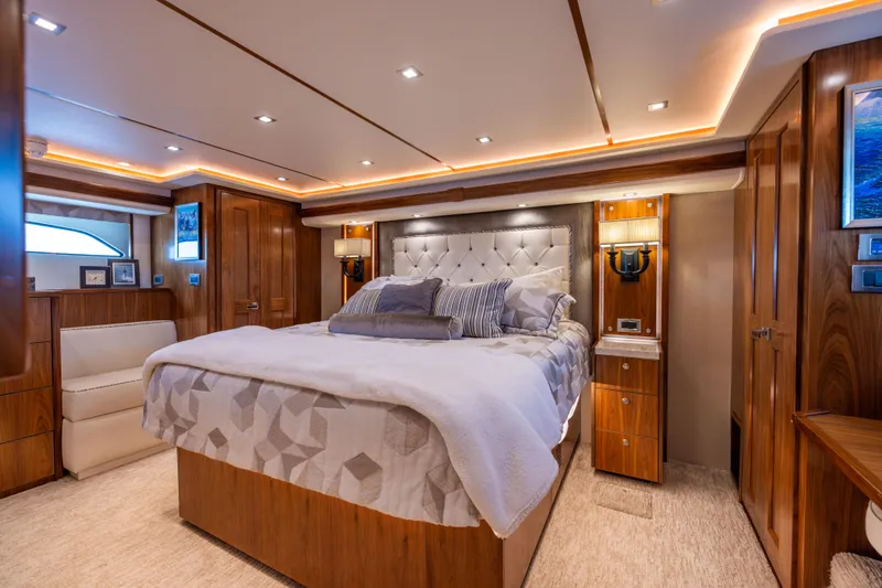 Slide: The Image of Luxurious bedroom interior of 2020 Viking 80 Convertible yacht with elegant wood finishes. - 24