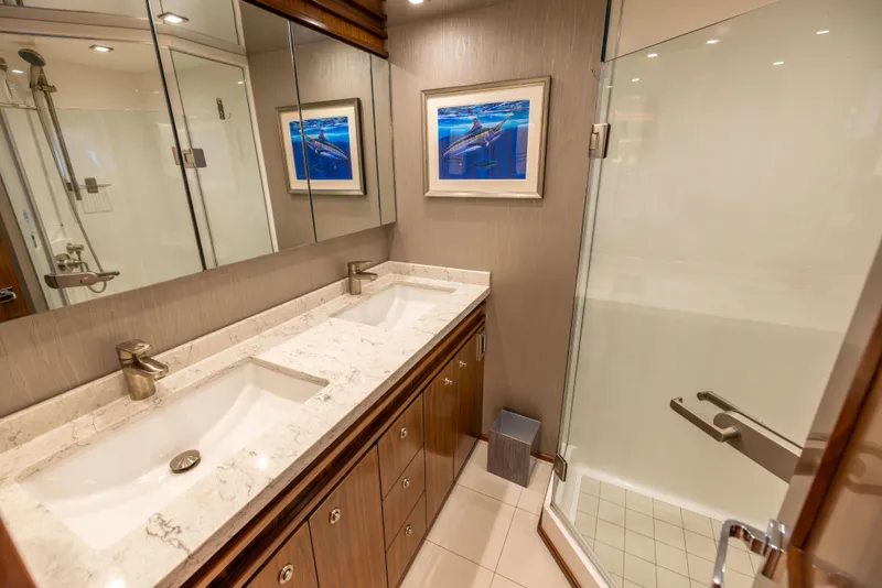 Slide: The Image of Luxurious bathroom in 2020 Viking 80 Convertible yacht with dual sinks and glass shower. - 27