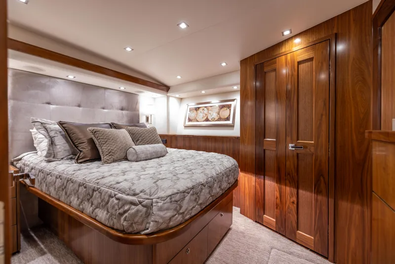 Slide: The Image of Luxurious bedroom interior of 2020 Viking 80 Convertible yacht with elegant wood finishes. - 28