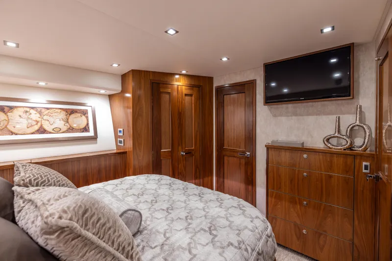 Slide: The Image of Luxurious bedroom interior of 2020 Viking 80 Convertible yacht with elegant wood finishes. - 29