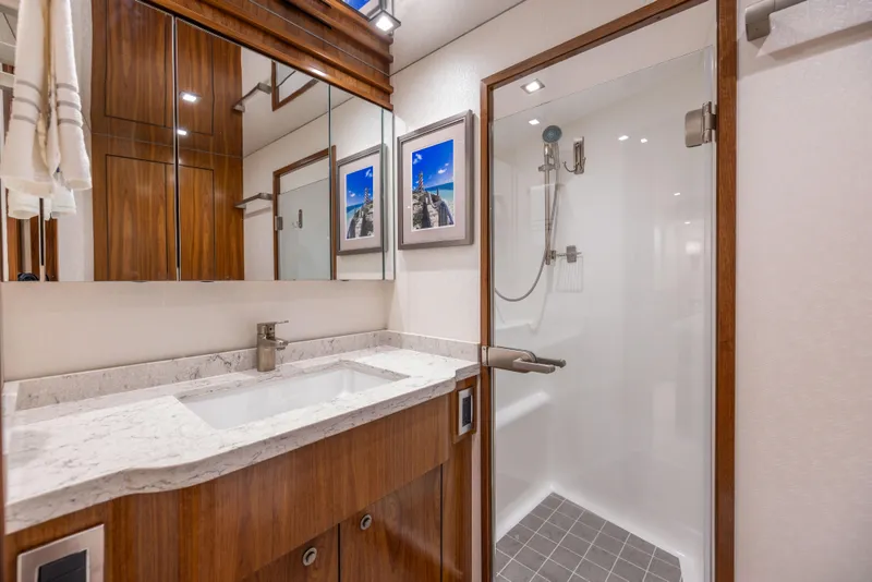 Slide: The Image of Luxurious bathroom in 2020 Viking 80 Convertible yacht with modern fixtures and elegant wood finishes. - 30