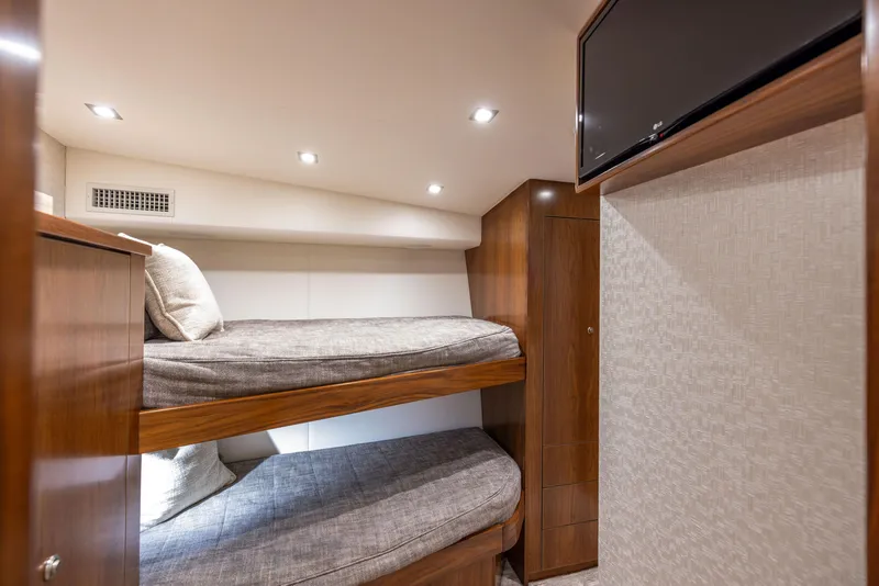 Slide: The Image of Interior of 2020 Viking 80 Convertible yacht with cozy bunk beds and modern lighting. - 31
