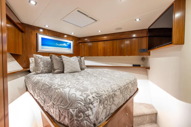 Slide: The Image of Luxurious bedroom interior of 2020 Viking 80 Convertible yacht with elegant bedding and wood finishes. - 37