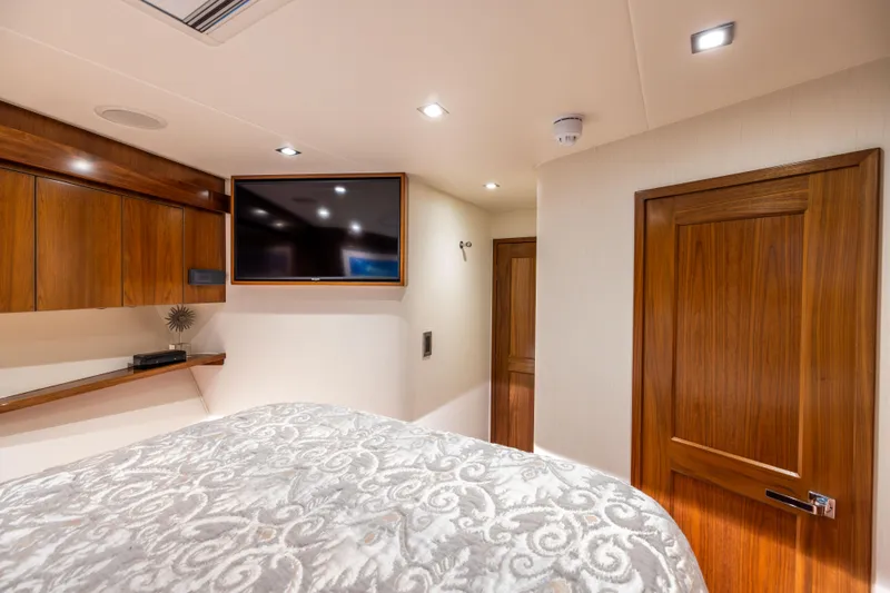 Slide: The Image of Luxurious cabin interior of 2020 Viking 80 Convertible yacht with wood accents and modern amenities. - 38