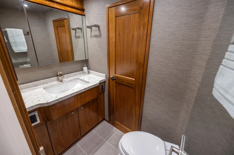 Slide: The Image of Luxurious bathroom in 2020 Viking 80 Convertible yacht with wood accents and modern fixtures. - 39