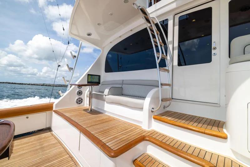 Slide: The Image of Luxury 2020 Viking 80 Convertible yacht with teak deck and elegant seating area. - 41