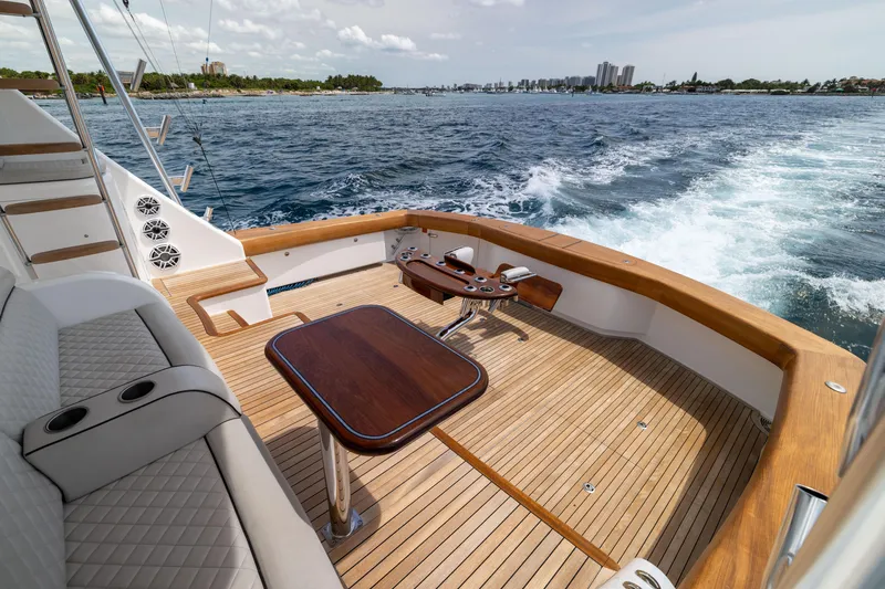 Slide: The Image of 2020 Viking 80 Convertible yacht deck with ocean view and seating area. - 46