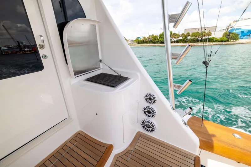 Slide: The Image of Viking 80 Convertible 2020 yacht deck with seating, speakers, and ocean view. - 47