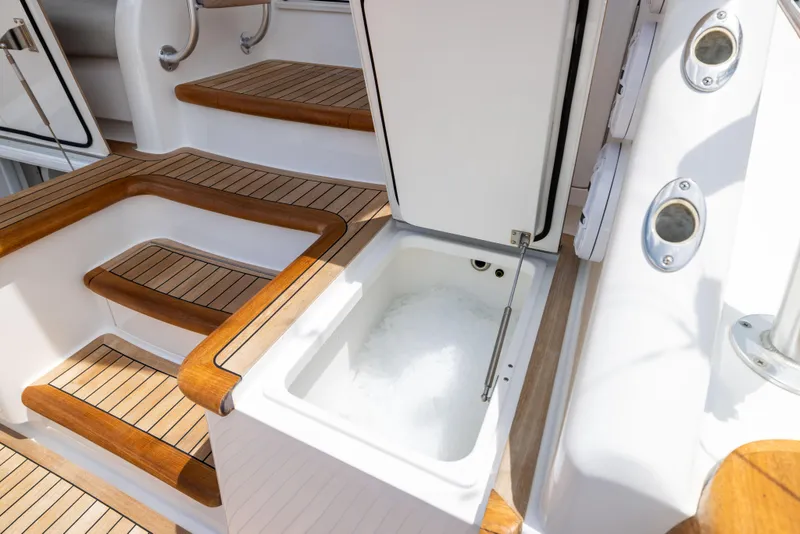 Slide: The Image of Luxury Viking 80 Convertible yacht with open storage compartment, teak steps, and sleek design, 2020 model. - 49