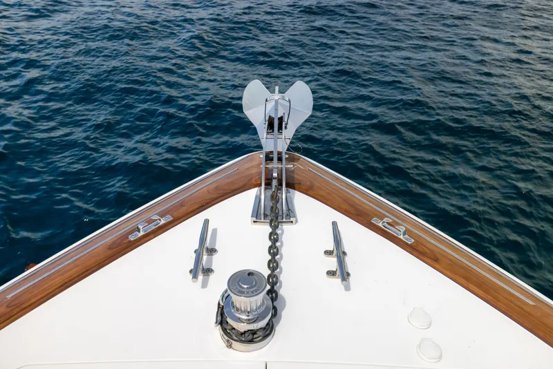 Slide: The Image of Bow of 2020 Viking 80 Convertible yacht with anchor chain over blue water. - 53