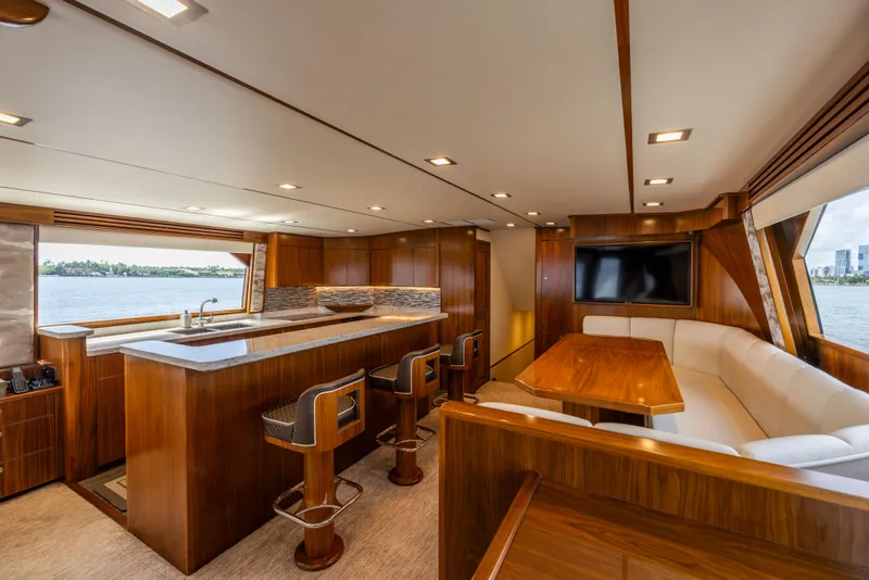 Slide: The Image of Luxurious interior of 2020 Viking 80 Convertible yacht with modern kitchen and dining area. - 9