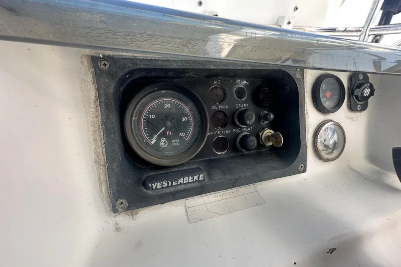 Slide: The Image of Control panel of a 2003 Beneteau Oceanis Clipper 331 sailboat, featuring gauges and switches. - 26