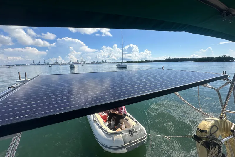 Slide: The Image of Beneteau Oceanis Clipper 331 with solar panel, docked in a scenic harbor, 2003 model. - 34