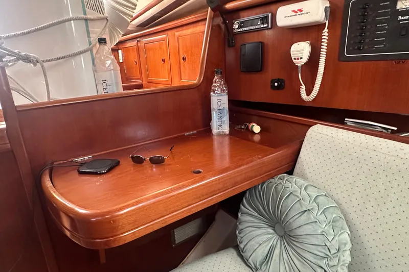 Slide: The Image of Interior of 2003 Beneteau Oceanis Clipper 331 with wooden desk, radio, and seating. - 39
