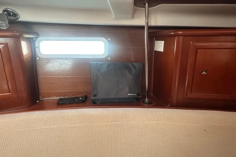 Slide: The Image of Interior of 2003 Beneteau Oceanis Clipper 331 with wooden cabinetry and porthole. - 44
