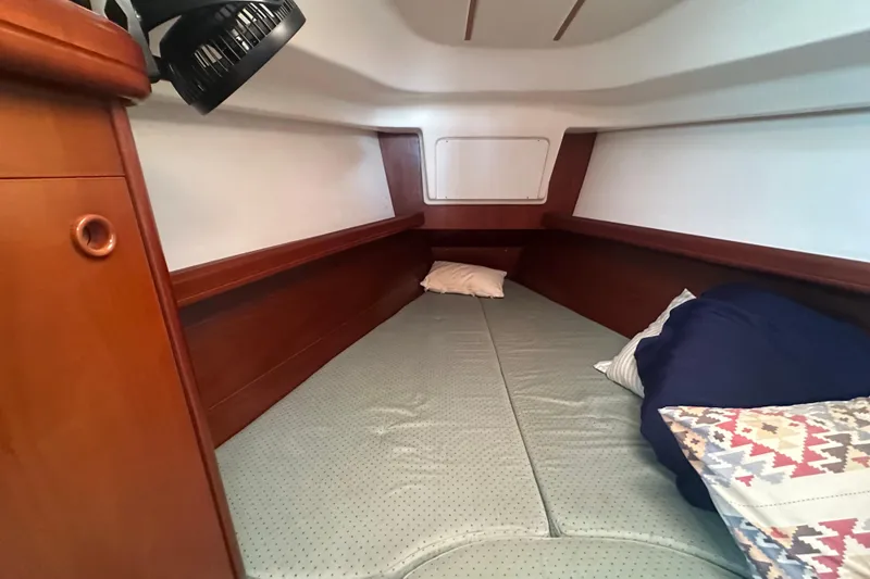 Slide: The Image of Cozy cabin interior of 2003 Beneteau Oceanis Clipper 331 sailboat with pillows and wood finish. - 49