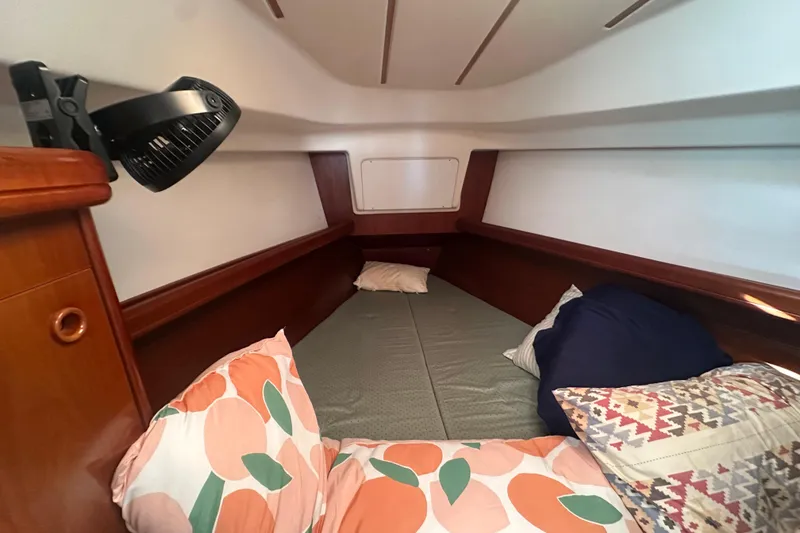 Slide: The Image of Cozy cabin interior of 2003 Beneteau Oceanis Clipper 331 with colorful pillows and compact fan. - 50