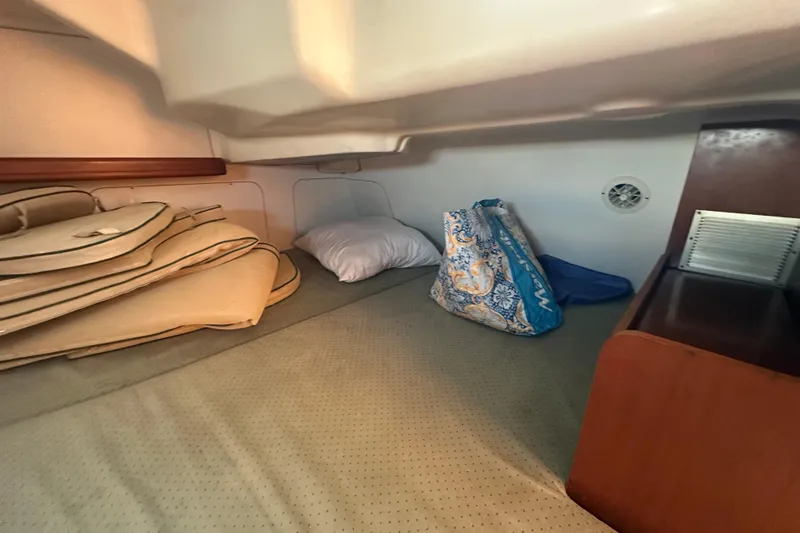 Slide: The Image of Cozy cabin interior of 2003 Beneteau Oceanis Clipper 331 sailboat with cushions and storage. - 51