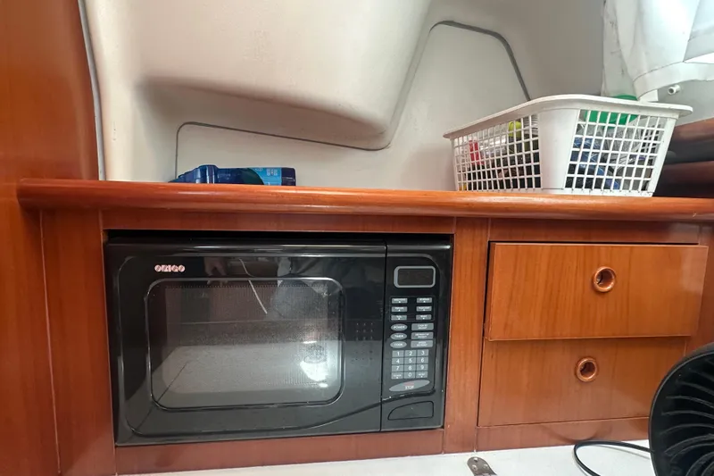 Slide: The Image of Microwave and storage in 2003 Beneteau Oceanis Clipper 331 yacht interior. - 57