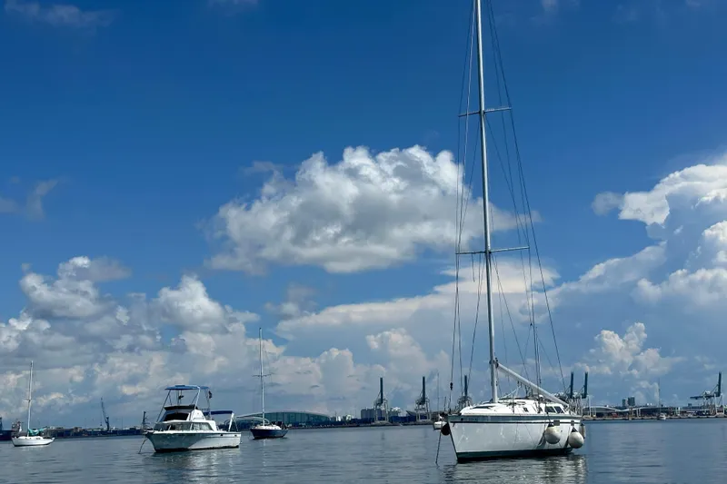 Slide: The Image of 2003 Beneteau Oceanis Clipper 331 sailboat on calm water under blue sky. - 6