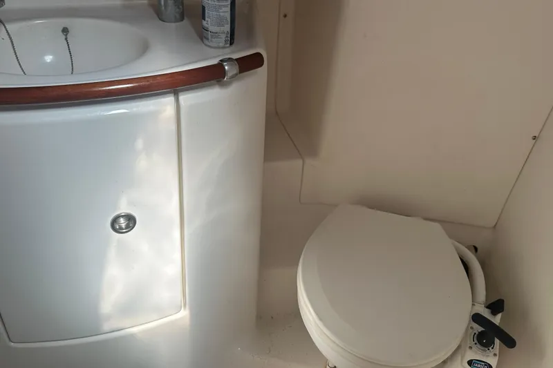 Slide: The Image of Bathroom interior of 2003 Beneteau Oceanis Clipper 331 yacht, featuring sink and toilet. - 63