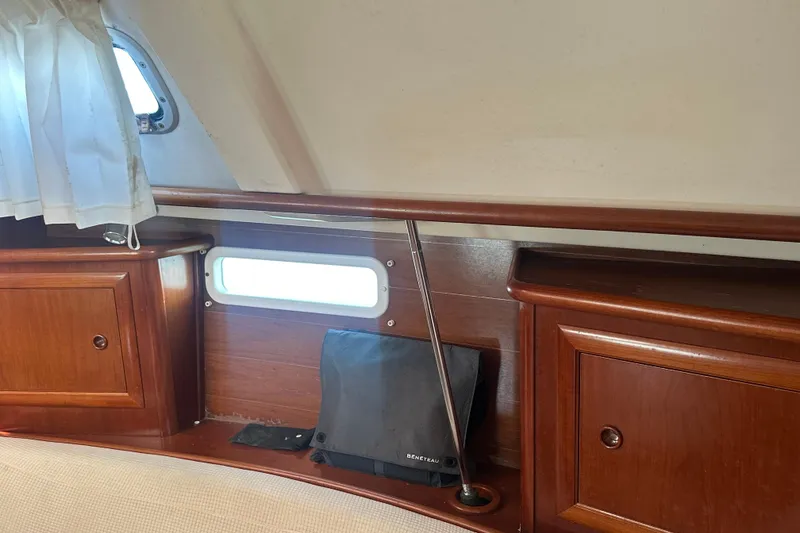 Slide: The Image of Interior of 2003 Beneteau Oceanis Clipper 331 with wooden cabinets and porthole. - 66