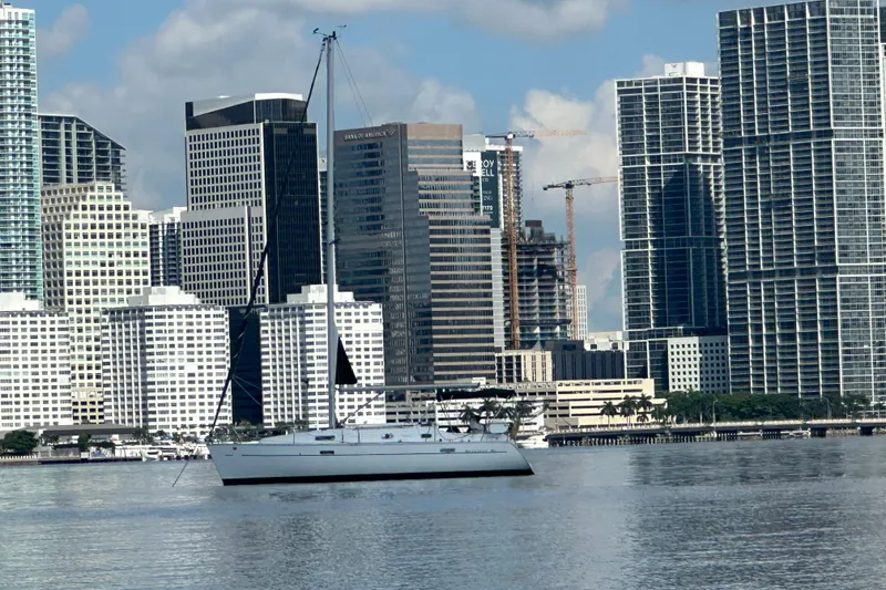 Slide: The Image of Sailboat Beneteau Oceanis Clipper 331, 2003, in urban waterfront setting with skyscrapers. - 8