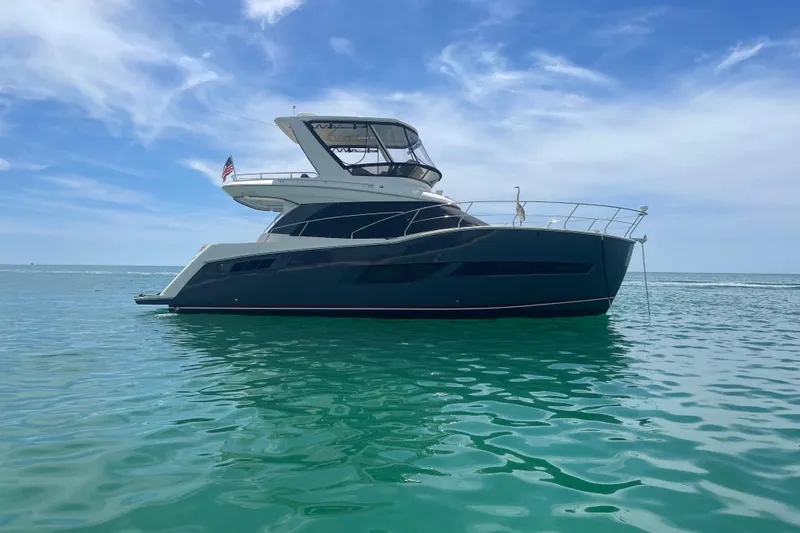 The Image of 2017 Carver C40 Command Bridge yacht on calm ocean waters under blue sky. - 0