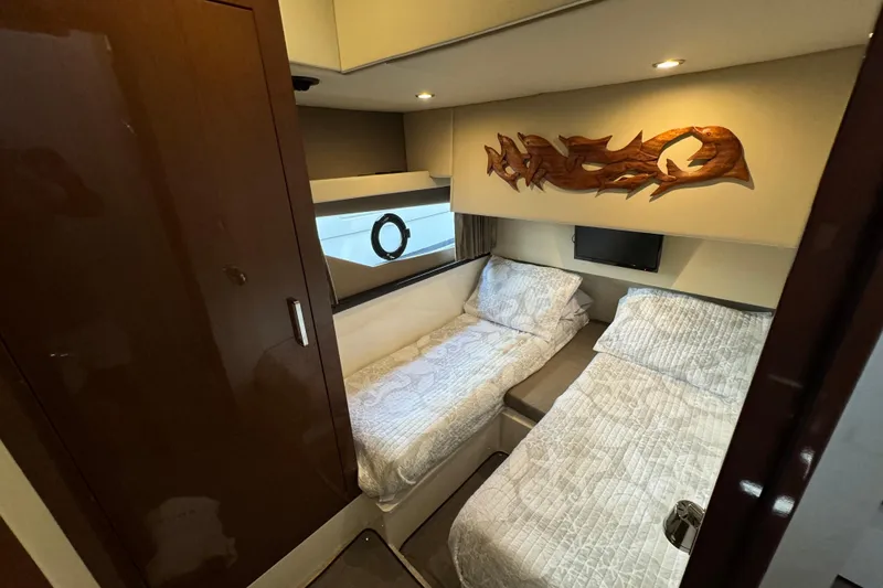 Slide: The Image of Interior of 2017 Carver C40 Command Bridge with twin beds and decorative wall art. - 13