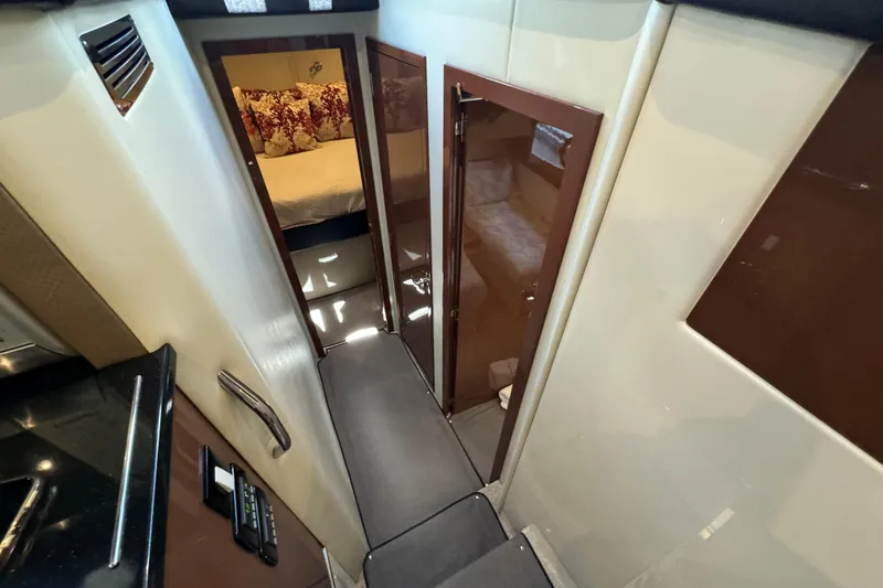 Slide: The Image of Interior view of 2017 Carver C40 Command Bridge yacht, featuring a cozy cabin hallway. - 14