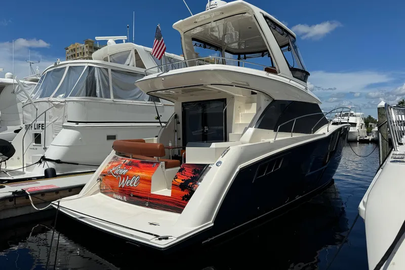 Slide: The Image of 2017 Carver C40 Command Bridge yacht docked at marina under clear blue sky. - 3