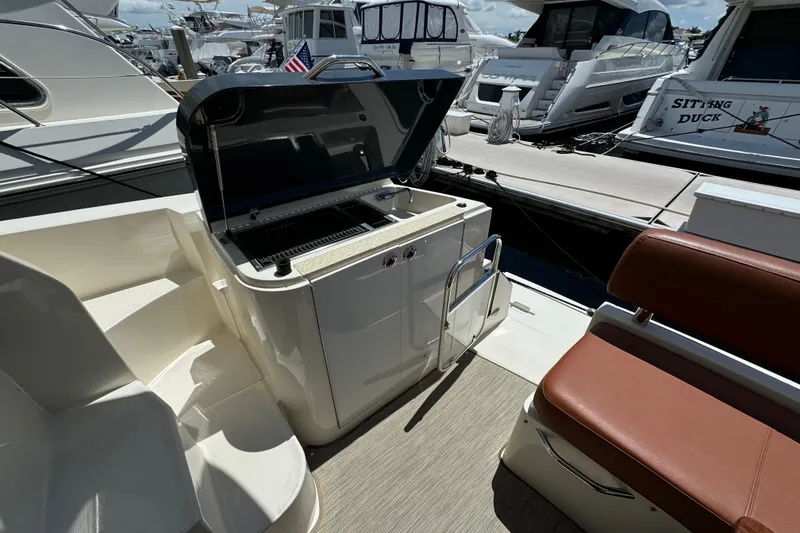 Slide: The Image of 2017 Carver C40 Command Bridge yacht with open grill and seating area at marina. - 6