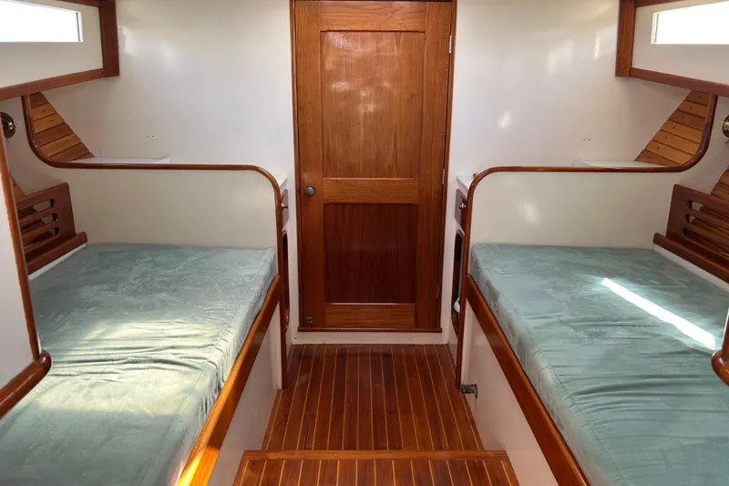 Slide: The Image of Interior of 1995 Holland Pettegrow Cruiser with twin beds and wooden finishes. - 14