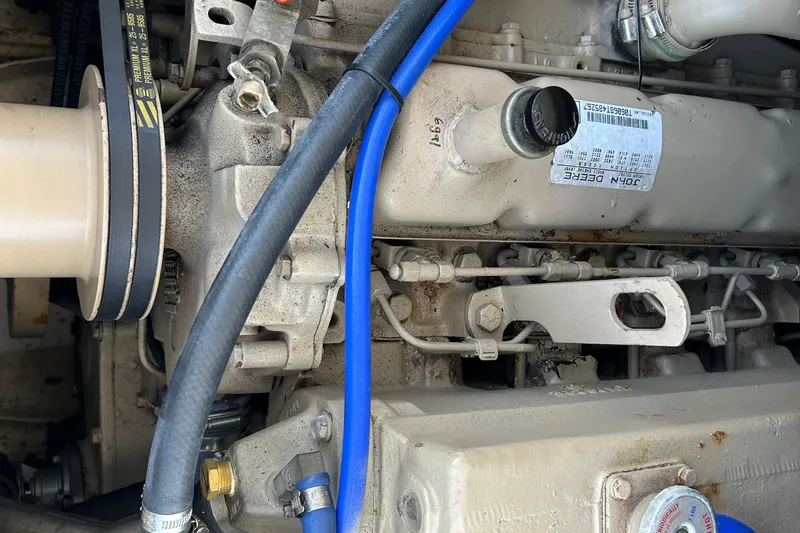 Slide: The Image of Engine components of a 1995 Holland Pettegrow Cruiser, featuring belts and hoses. - 16