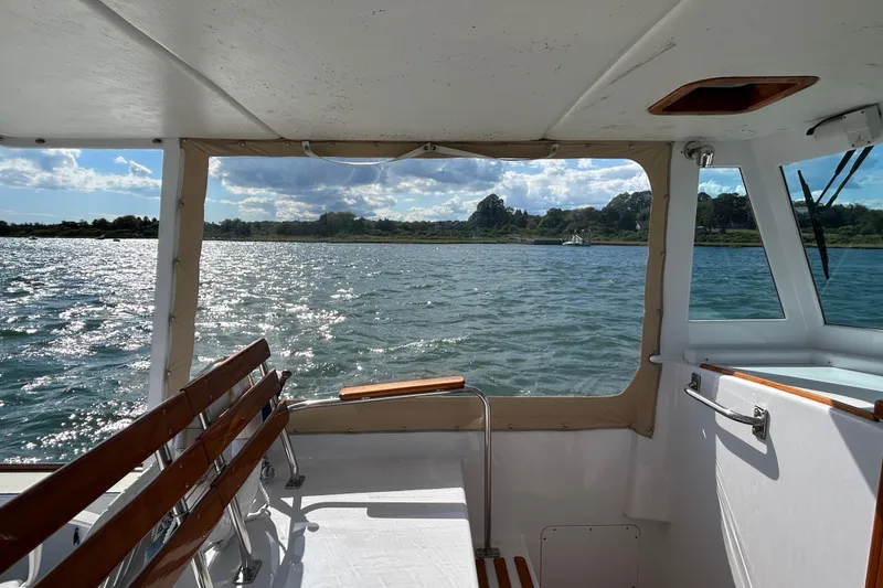 Slide: The Image of 1995 Holland Pettegrow Cruiser interior with scenic water view through windows. - 19