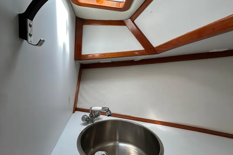Slide: The Image of Interior of 1995 Holland Pettegrow Cruiser with sink and wooden trim. - 23