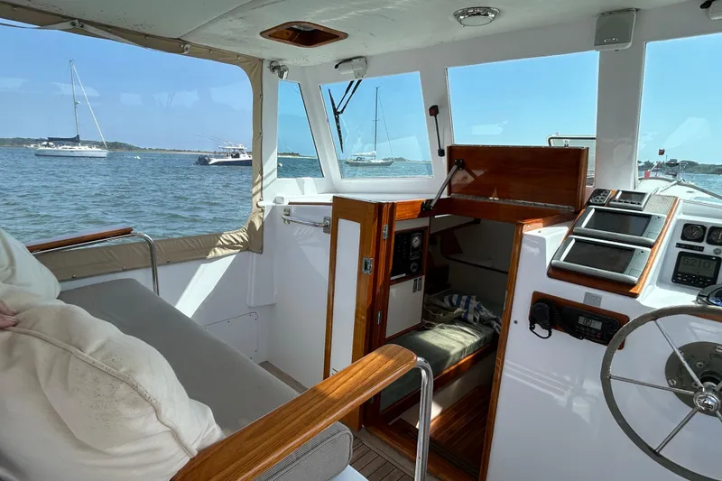 Slide: The Image of Interior of a 1995 Holland Pettegrow Cruiser with nautical views and navigation equipment. - 8