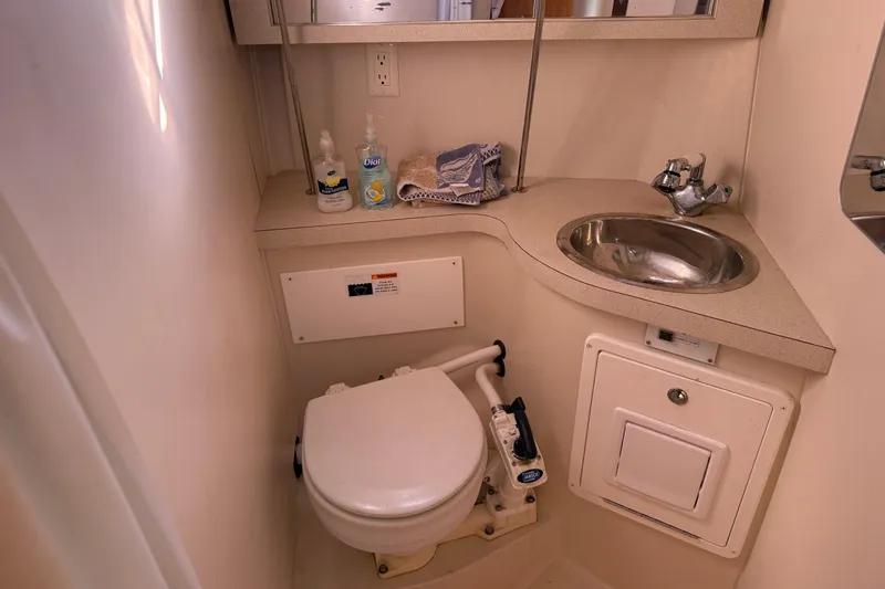 Slide: The Image of Compact bathroom in a 2008 Catalina 310 yacht with sink and toilet. - 12