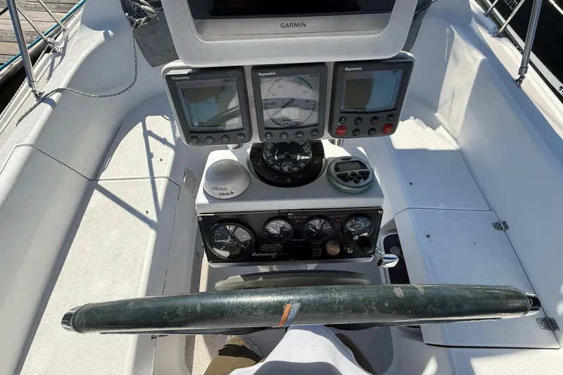 Slide: The Image of Cockpit of 2008 Catalina 310 sailboat with navigation instruments and steering wheel. - 14
