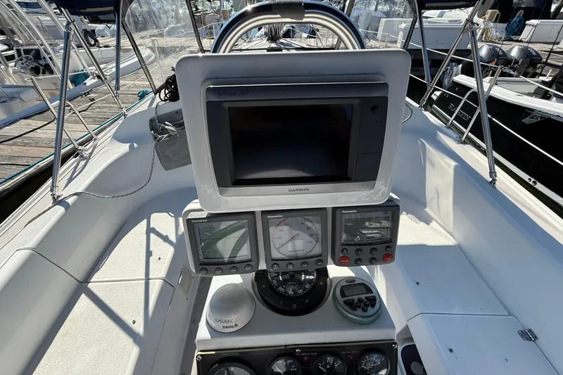 Slide: The Image of Cockpit of 2008 Catalina 310 sailboat with navigation instruments and Garmin display. - 15