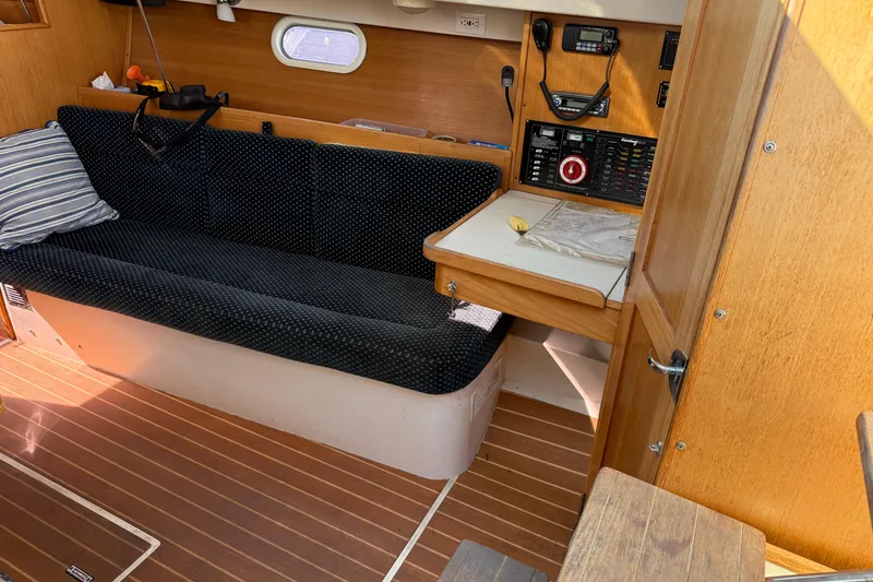 Slide: The Image of Interior of a 2008 Catalina 310 sailboat with seating and navigation station. - 17
