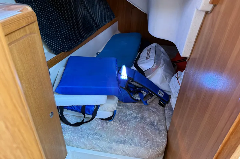 Slide: The Image of Interior of a 2008 Catalina 310 sailboat with cushions and gear storage. - 8