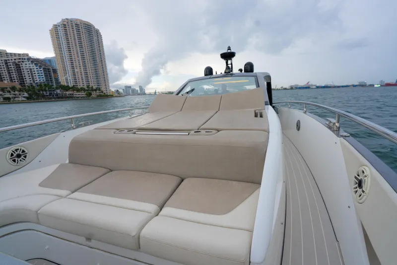 Slide: The Image of 2021 Azimut Verve 47 yacht with luxurious deck seating, cruising near city skyline. - 23