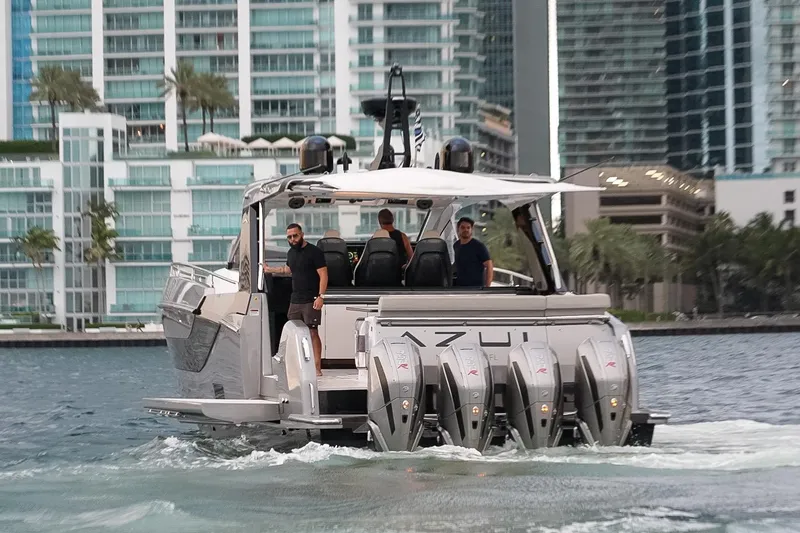 Slide: The Image of 2021 Azimut Verve 47 yacht cruising near modern waterfront buildings. - 3