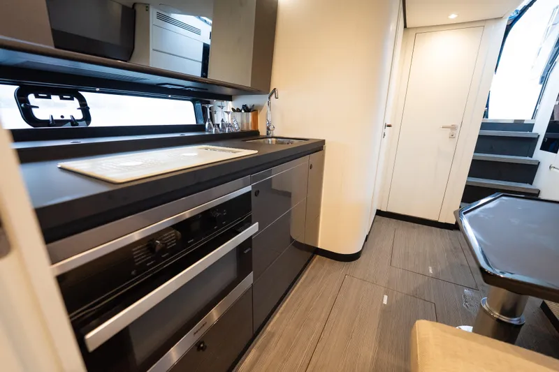 Slide: The Image of Modern kitchen interior of 2021 Azimut Verve 47 yacht, featuring sleek cabinetry and appliances. - 33