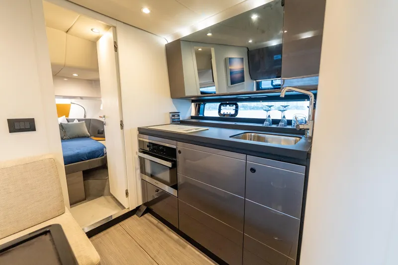 Slide: The Image of Luxurious interior of 2021 Azimut Verve 47 yacht featuring modern kitchen and cozy bedroom. - 34