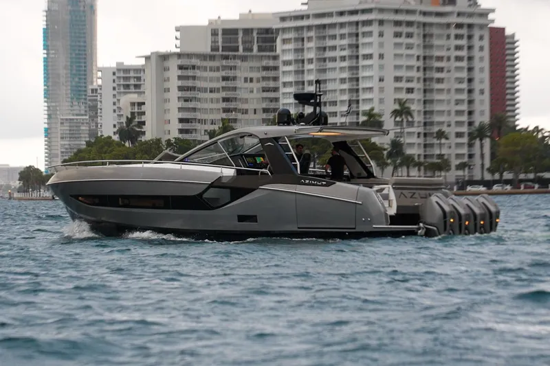 Slide: The Image of 2021 Azimut Verve 47 yacht cruising near urban waterfront buildings. - 4