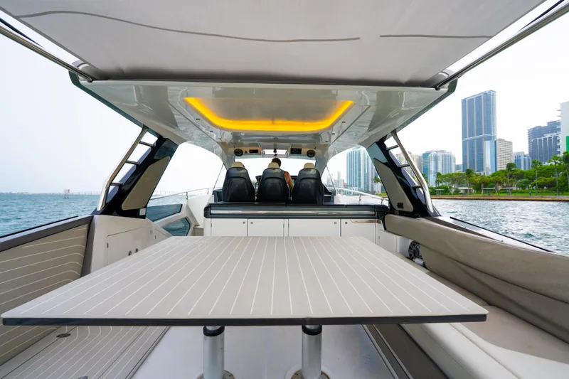 Slide: The Image of Azimut Verve 47 yacht interior, 2021 model, with modern seating and city skyline view. - 7